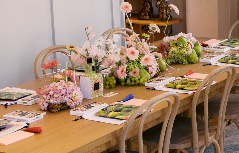 Styled tablescape from the Voluspa Petal & Pair Masterclass at Fashion Island featuring floral arrangements and fragrance displays